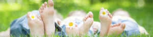 child's toes with daisy flowers