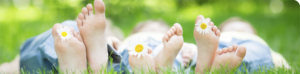 child's toes with daisy flowers
